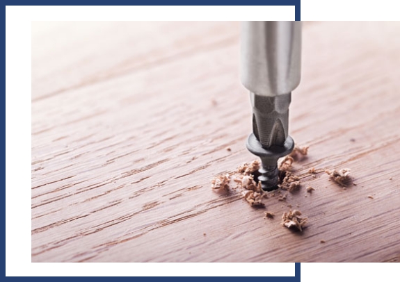 Driving a screw into a wood board