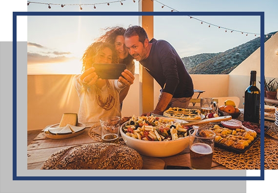 Three friends taking selfie in back yard who need automatic exterior patio shades to have a better outdoor experience.